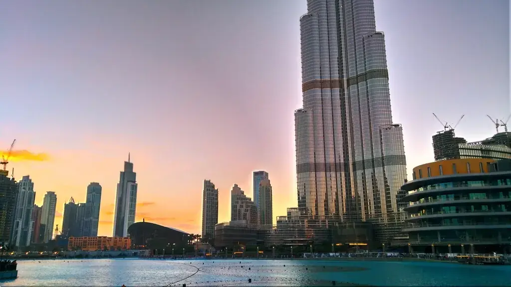Burj Khalifa and the Dubai Fountain lake at sunset